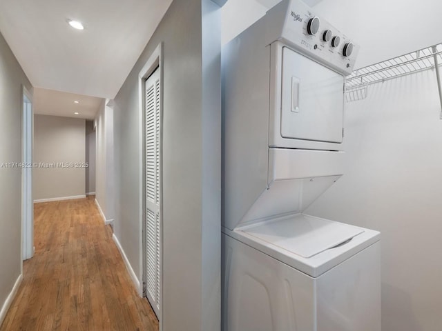 1018 Meridian Ave Unit 4, Miami Beach, FL 33139 - laundry area with estacked washer and dryer, wood finished floors, recessed lighting, and baseboards