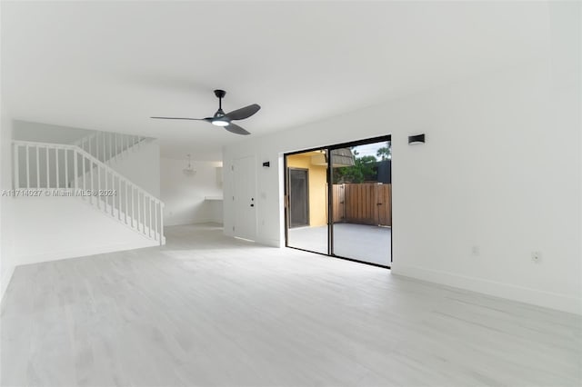 unfurnished living room with ceiling fan and light wood-type flooring