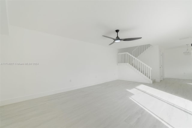 unfurnished living room with ceiling fan and light hardwood / wood-style flooring