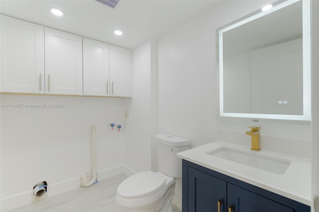 bathroom with vanity and toilet