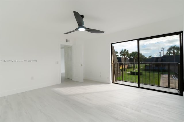 empty room featuring light wood-type flooring and ceiling fan