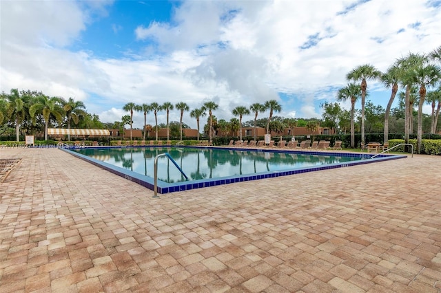 view of swimming pool with a water view