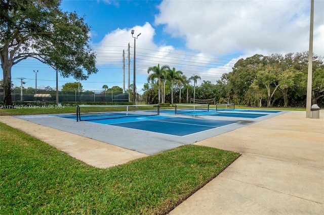 view of swimming pool featuring tennis court