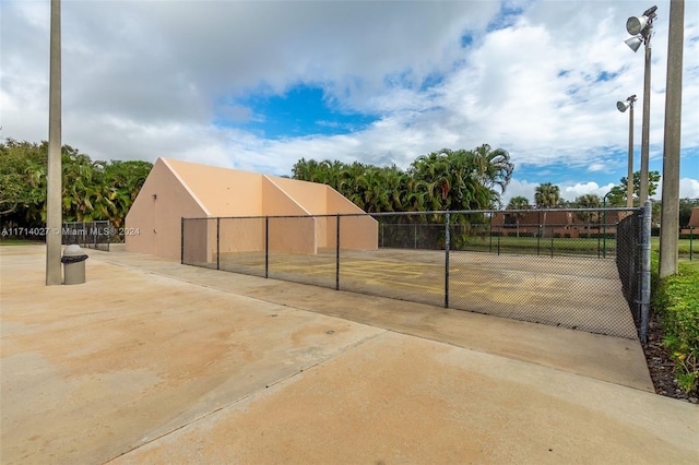 view of home's community featuring tennis court