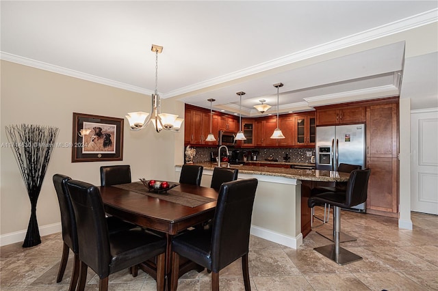 dining area featuring crown molding, sink, and a notable chandelier