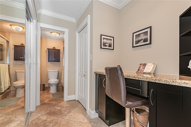 office area with built in desk and ornamental molding