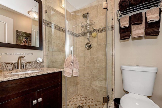 bathroom featuring vanity, toilet, and walk in shower