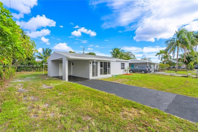 exterior space featuring a yard and a carport