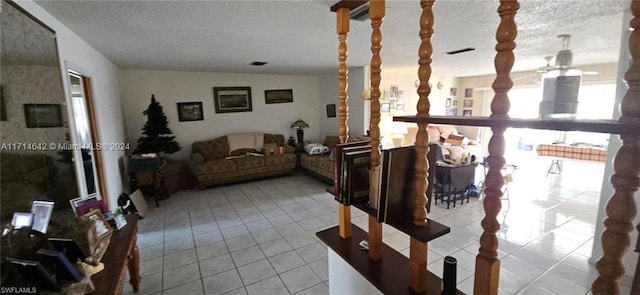 living room with light tile patterned floors and a textured ceiling