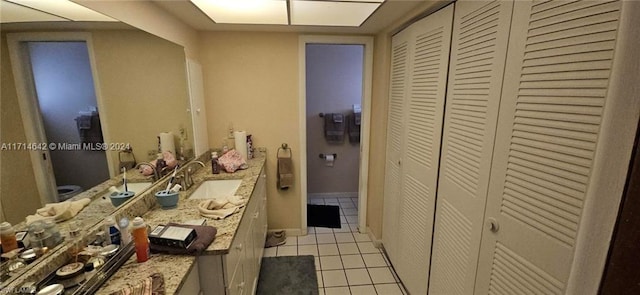 bathroom featuring tile patterned flooring and vanity