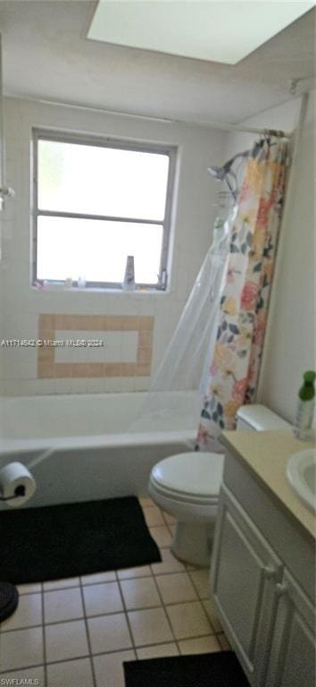 full bathroom with tile patterned flooring, vanity, toilet, and plenty of natural light