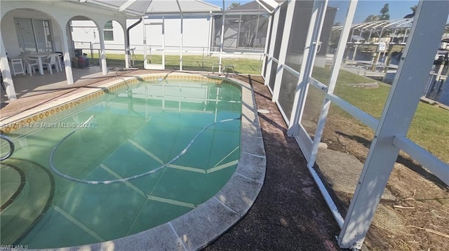 view of swimming pool with a lawn and glass enclosure