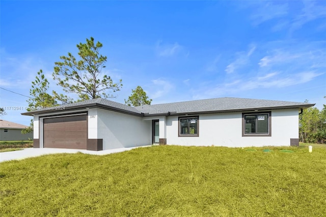 ranch-style home featuring a garage and a front yard