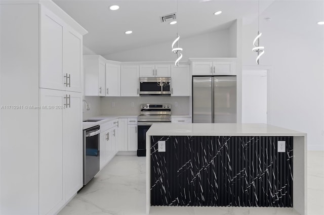 kitchen featuring a center island, white cabinets, pendant lighting, and appliances with stainless steel finishes