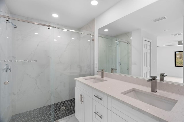 full bathroom with a marble finish shower, recessed lighting, double vanity, and marble look tiles