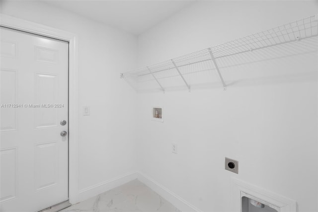 laundry room with electric dryer hookup, hookup for a washing machine, baseboards, and marble finish flooring