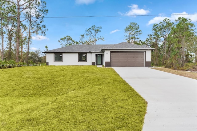 view of front of home featuring a garage and a front lawn