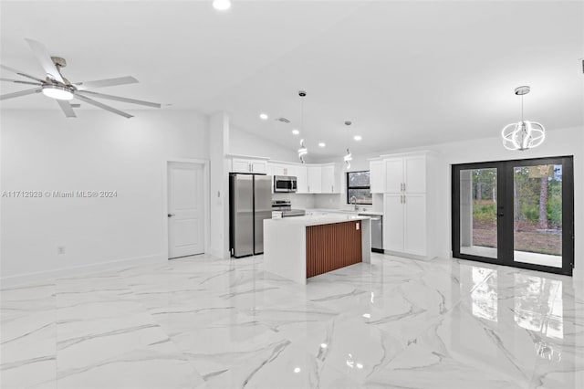 kitchen with white cabinetry, a kitchen island, stainless steel appliances, and decorative light fixtures