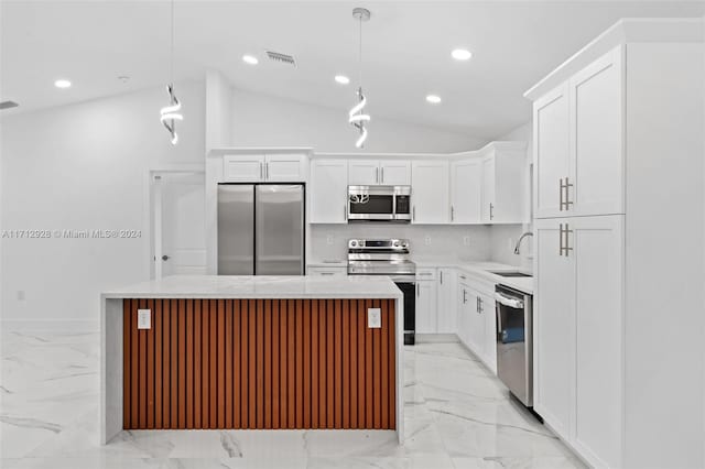 kitchen with pendant lighting, a center island, stainless steel appliances, and sink