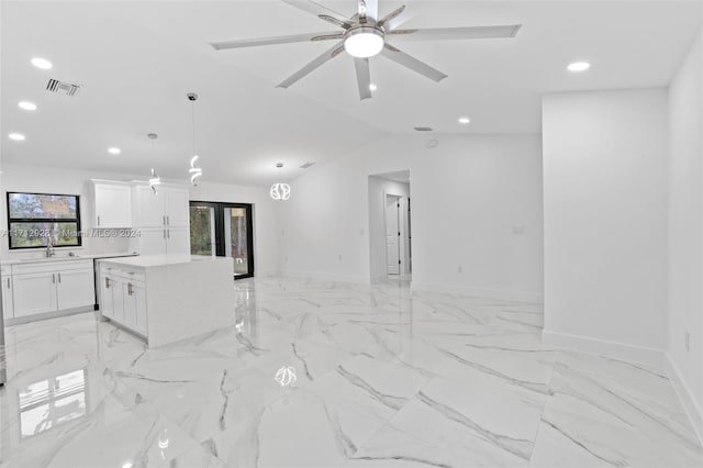 interior space with lofted ceiling, ceiling fan, sink, and french doors