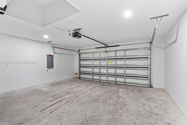 garage featuring electric panel and a garage door opener