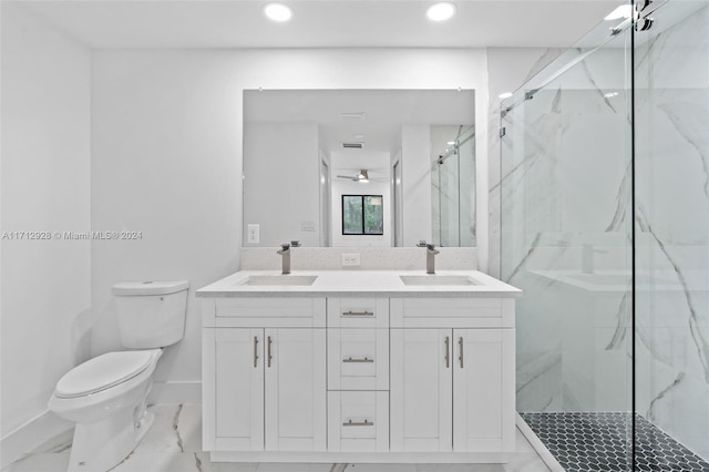 bathroom with vanity, a shower with shower door, and toilet