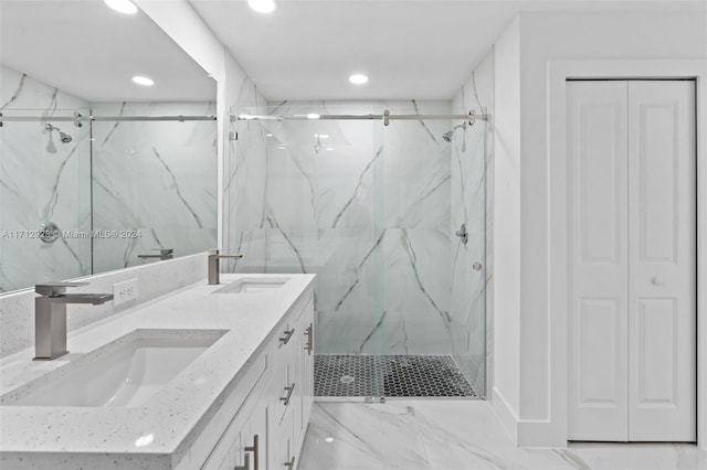 bathroom with a shower with door and vanity