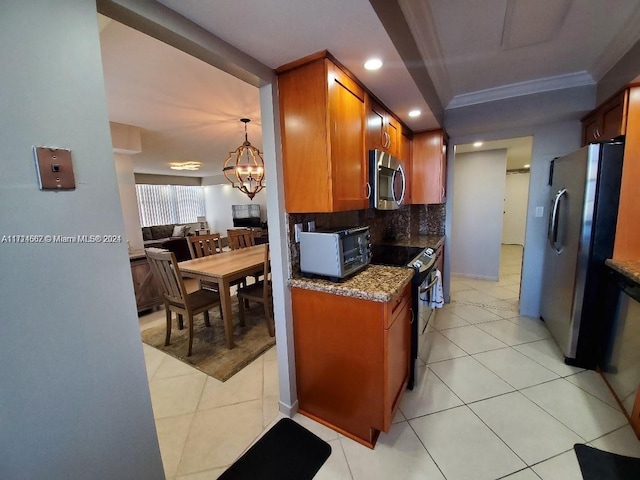 kitchen featuring appliances with stainless steel finishes, tasteful backsplash, crown molding, an inviting chandelier, and stone counters