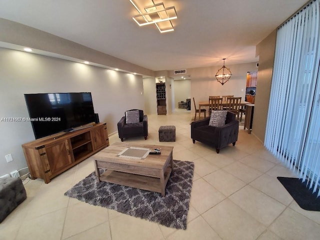 living room featuring light tile patterned floors and a chandelier