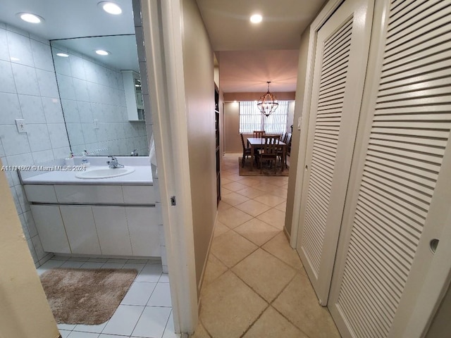 bathroom featuring tile patterned floors, vanity, and a chandelier