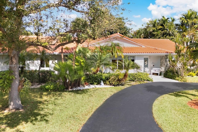 mediterranean / spanish-style home featuring a front lawn