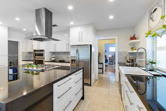 kitchen with white cabinetry, decorative backsplash, appliances with stainless steel finishes, and island exhaust hood