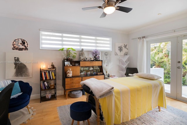 bedroom with multiple windows, access to exterior, ceiling fan, and light hardwood / wood-style floors