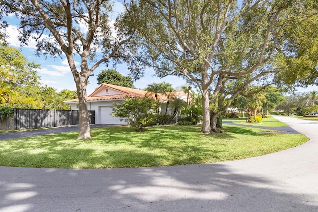 view of front of property featuring a garage and a front yard