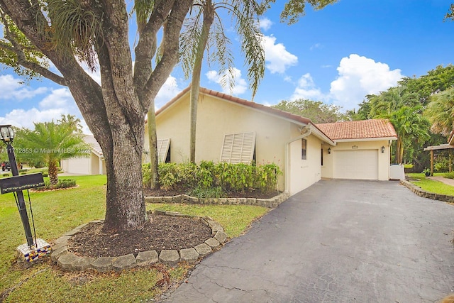 view of front of property with a front yard and a garage