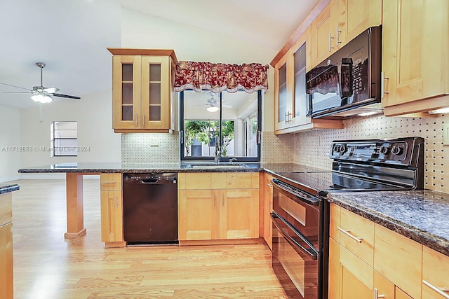 kitchen with black appliances, lofted ceiling, sink, and light brown cabinetry