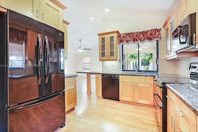 kitchen with ceiling fan, tasteful backsplash, dark stone countertops, vaulted ceiling, and black appliances