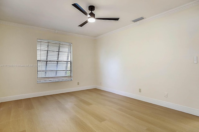 unfurnished room with ceiling fan, light wood-type flooring, and crown molding