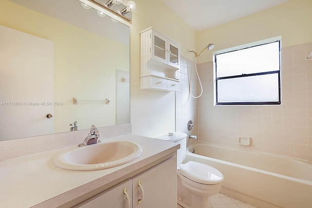 full bathroom with tile patterned floors, vanity, tiled shower / bath combo, and toilet