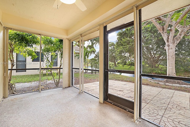 unfurnished sunroom featuring ceiling fan