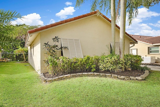 view of side of home featuring a lawn