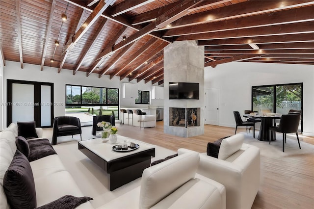 living room featuring wood ceiling, a fireplace, and light hardwood / wood-style floors