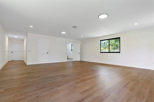 empty room with light hardwood / wood-style floors