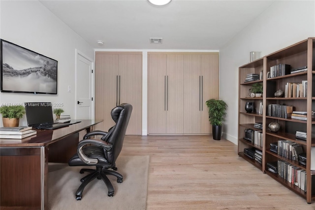 office with light hardwood / wood-style flooring