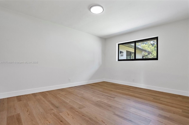 spare room with light hardwood / wood-style flooring