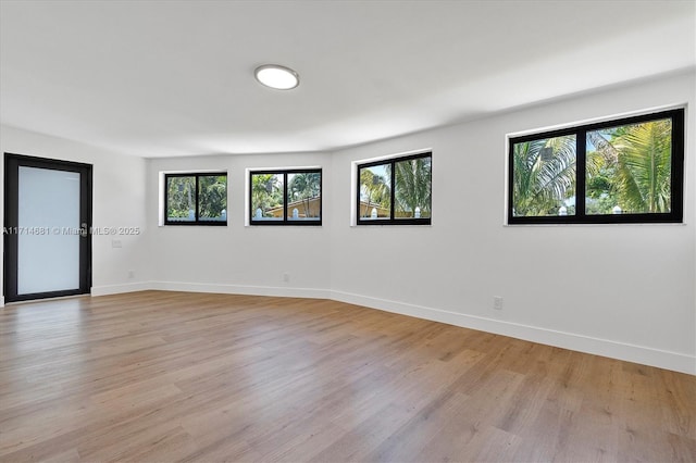 unfurnished room with light hardwood / wood-style flooring