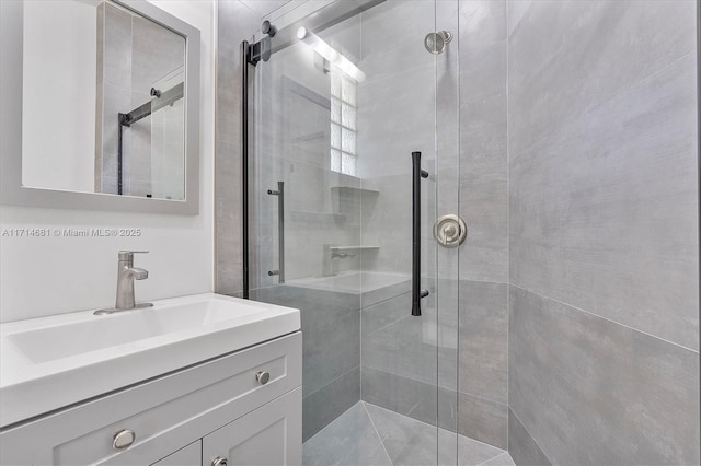 bathroom featuring vanity and a shower with shower door