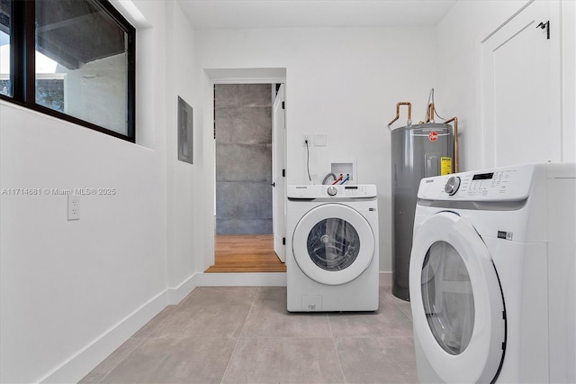 laundry area featuring light tile patterned flooring, washing machine and dryer, and water heater