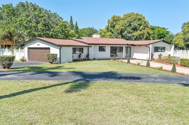 ranch-style home with a garage and a front yard