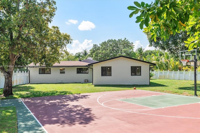 view of basketball court featuring a yard